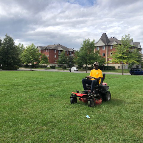 Employee on a riding lawnmower